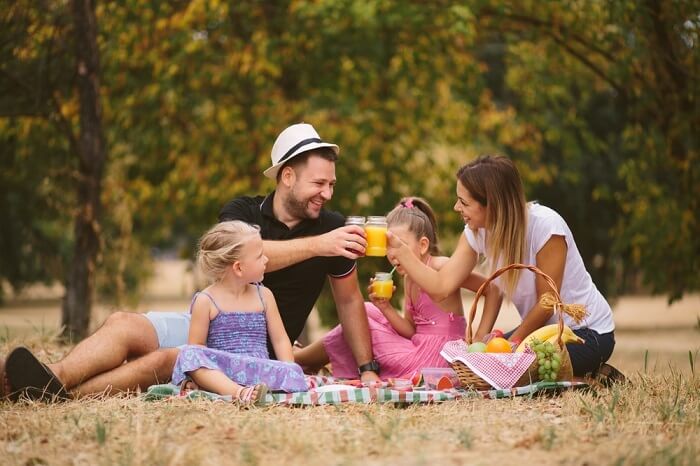 family drinking juice on camping